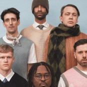 5 men posing against blue background